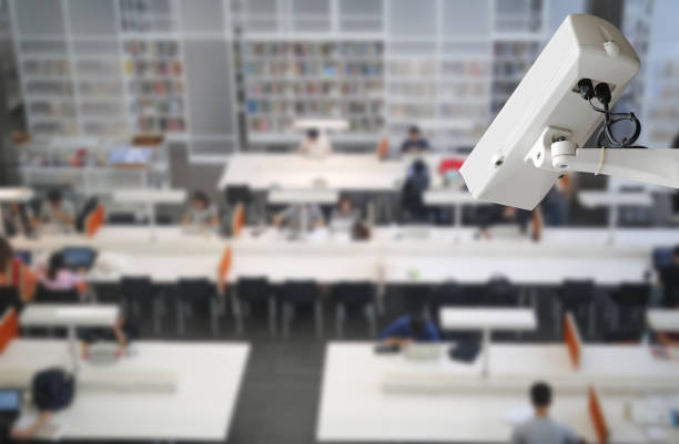 istock CCTV Camera Record on blurred background of people in the library, Security and safety concept.CCTV Camera Record on blurred background of people in the library, Security and safety concept. 827194314