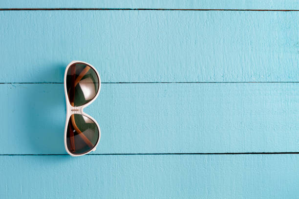 istock sunglasses on blue wooden background copy space for your text and design or background. 827201452