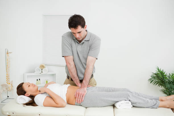 istock Peaceful woman being touched by an osteopath 827205972