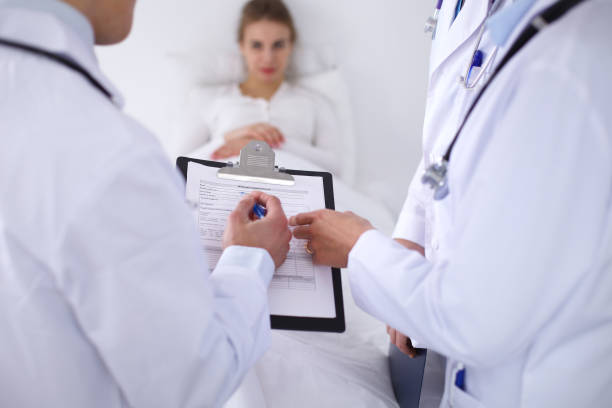istock A group of doctors discussing medical history close up 827211182