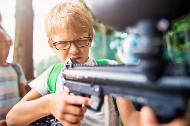 istock Little boy target shooting with painball gun 827211266