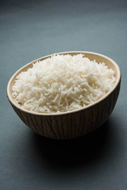 istock basmati rice in a ceramic bowl, indian white and long basmati rice cooked and served in bowl, selective focus 827211318