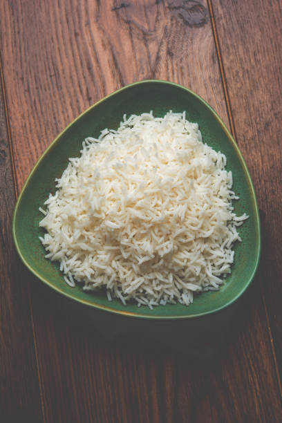 istock basmati rice in a ceramic bowl, indian white and long basmati rice cooked and served in bowl, selective focus 827211658