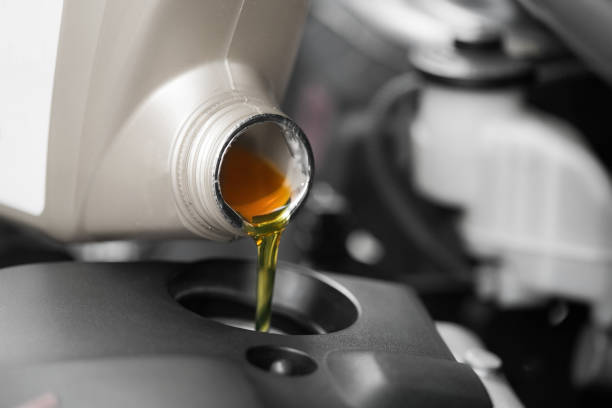 istock Close up, Pouring motor oil to car engine. 827211788
