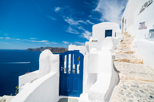 beautiful greek aegaean house overlooking the kaldera of santorini, a famous island of the cyclades in greece with its typical white walls and blue doors