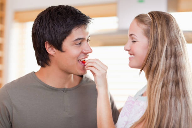 istock Woman feeding her fiance 827215058