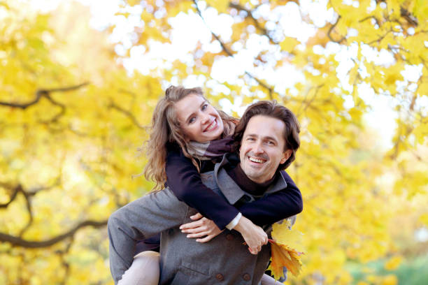 istock Couple having fun in autumn park 827215298