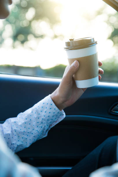 istock Man holding coffee in car 827215892