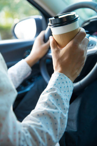 istock Man holding coffee in car 827215924