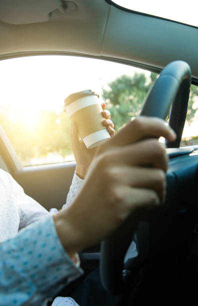 istock Man holding coffee in car 827215930