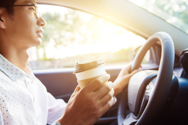 istock Man holding coffee in car 827215936