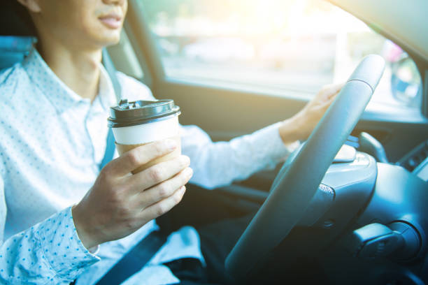 istock Man holding coffee,driving a car 827216070