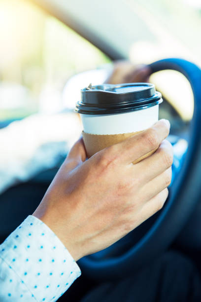 istock Man holding coffee,driving a car 827216152