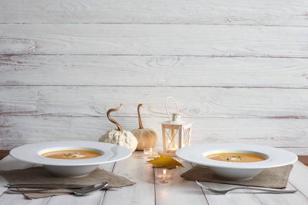 istock Romantic halloween dinner with pumpkin soup 827218704