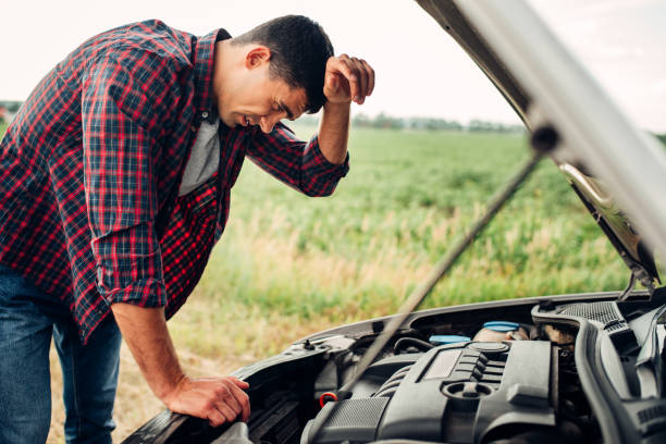 istock Tired man tries to repair a broken car 827219812