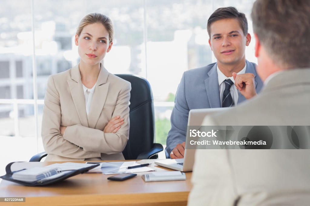Happy business people interviewing business man Happy business people interviewing business man in the office Gesturing Stock Photo