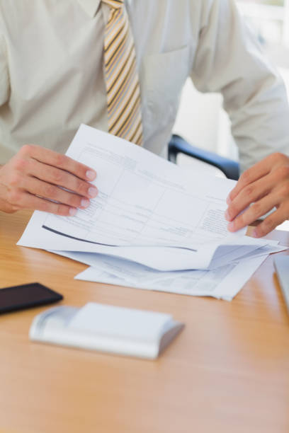 istock Hands of businessman turning a page 827223546