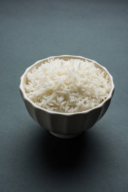istock basmati rice in a ceramic bowl, indian white and long basmati rice cooked and served in bowl, selective focus 827227318