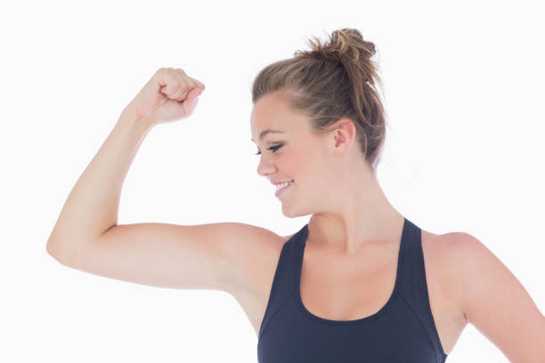 istock Woman standing showing her muscles 827234140
