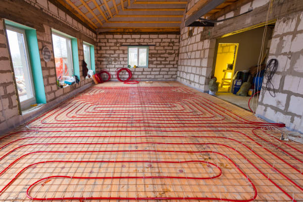 istock Pipefitter installing system of heating or underfloor heating installation. Water floor heating system interior. Plumbing pipes in apartment during under renovation, remodeling and construction. 827234206