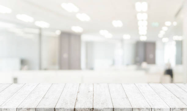 istock Wood table top and blurred bokeh office interior space background - can used for display or montage your products. 827234524