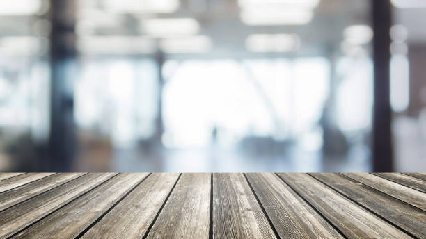 istock Wood table top and blurred bokeh office interior space background - can used for display or montage your products. 827234556