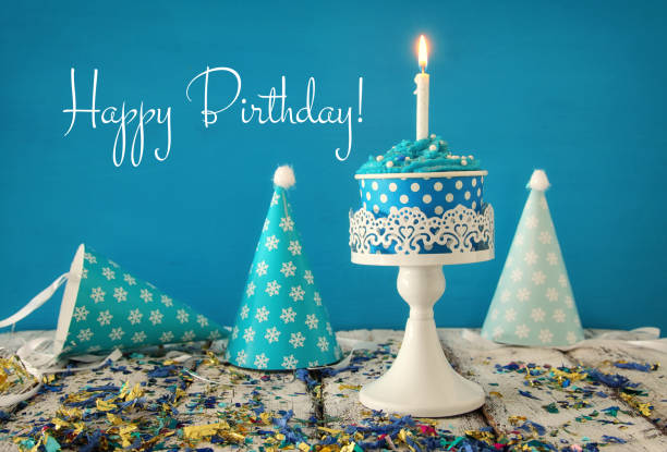 istock Birthday concept with cupcake and candle on wooden table 827235478