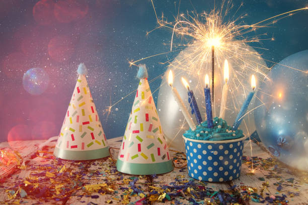 istock Birthday concept with cupcake and candles on wooden table 827235626
