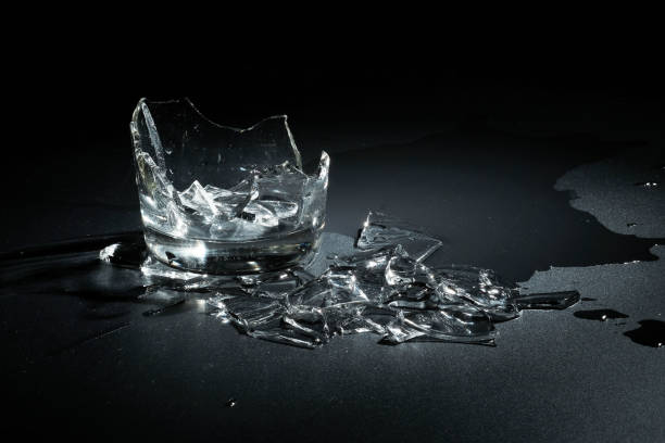 istock A breaking glass of water on the black background 827239002