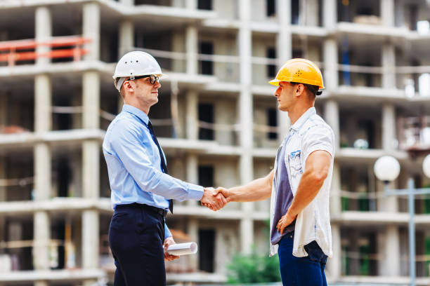 istock Architect engineer shaking hands other hand at construction site.  Business teamwork, cooperation, success collaboration concep 827239110