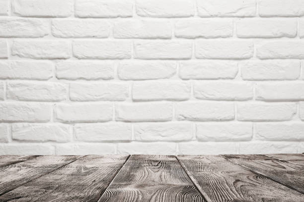 Wooden table over white brick wall Empty wooden table over white brick wall background with copy space brick cafe stock pictures, royalty-free photos & images