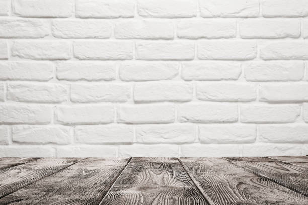 Wooden table over white brick wall Empty wooden table over white brick wall background with copy space commercial kitchen photos stock pictures, royalty-free photos & images