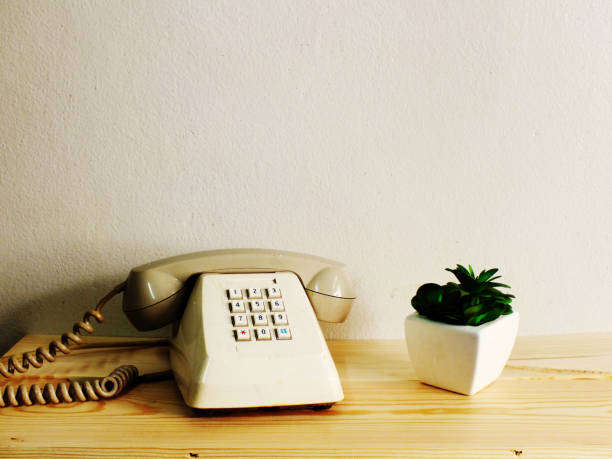 istock retro telephone on wood table wall background 827239216