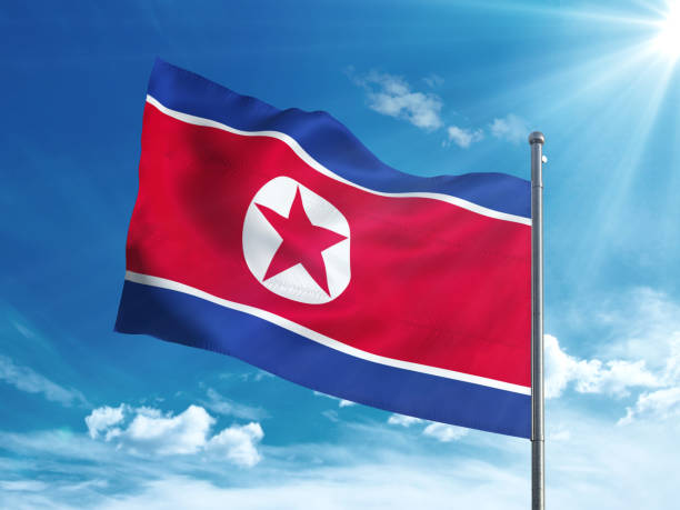 istock North Korea flag waving in the blue sky 827242080