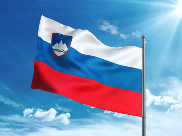 istock Slovenia flag waving in the blue sky 827242216