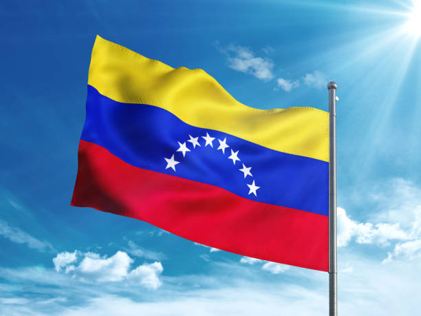 istock Venezuela flag waving in the blue sky 827242392