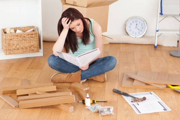 istock Good looking redhaired girl being depressed while reading a manual before do-it-yourself 827243486