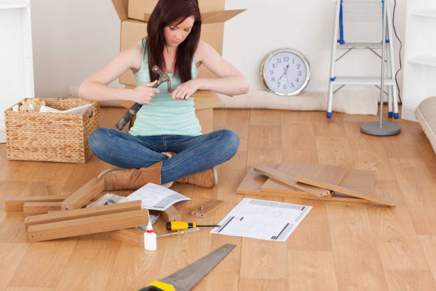 istock Beautiful redhaired girl using a hammer for diy 827243500