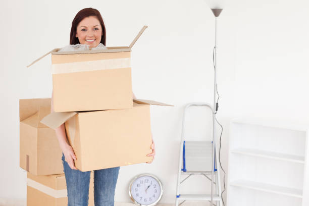 istock Attractive redhaired woman holding some carboard boxes 827243678