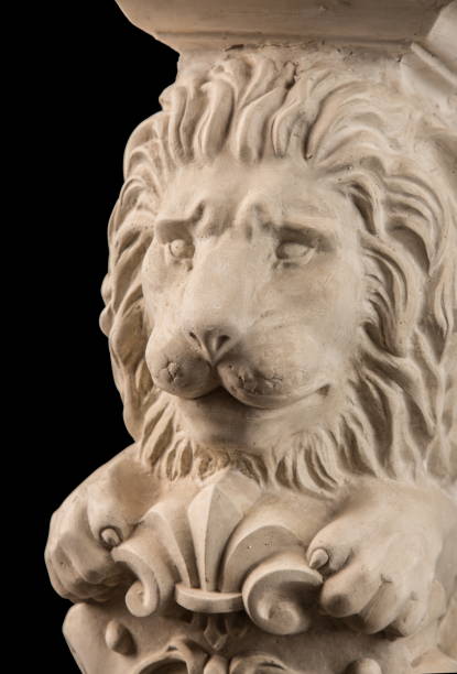 istock plaster lion sculpture, pommel column on a black background 827246528