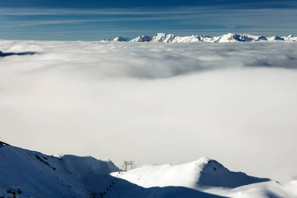 Ski Slope on foreground and clouds covering valley on background