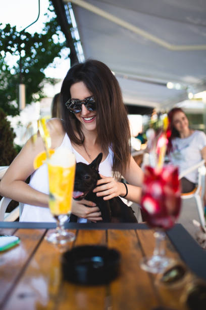 istock Woman with dog in cafe 827255444