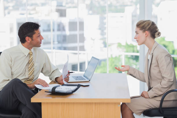 istock Businessman interviewing a businesswoman 827255614
