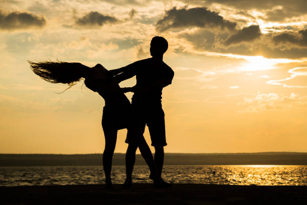 istock Couple dancing at the beach 827261600