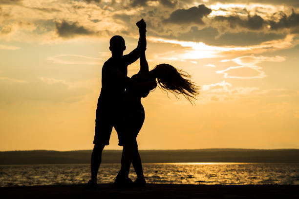 istock Couple dancing at the beach 827261604