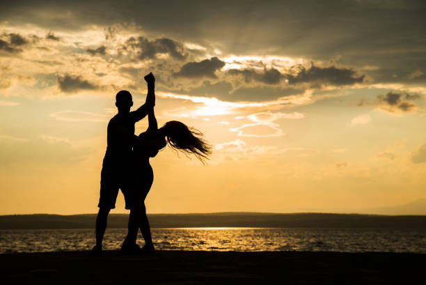 istock Couple dancing at the beach 827261606