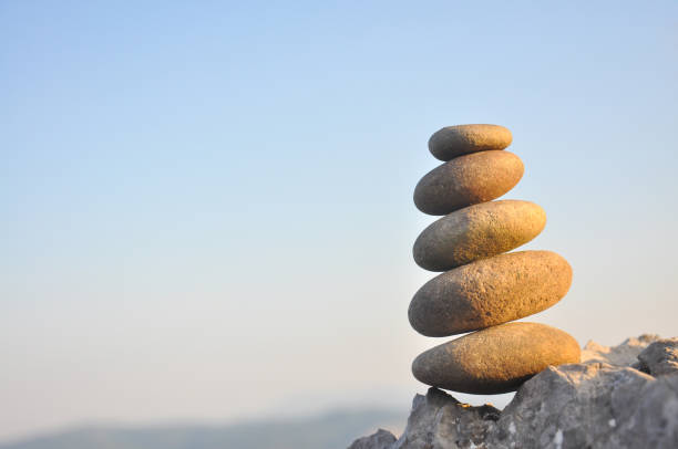 Balanced stone pyramid on mountain.