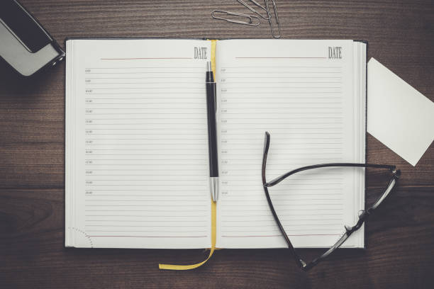 istock personal organizer and pen with glasses on the table 827270178