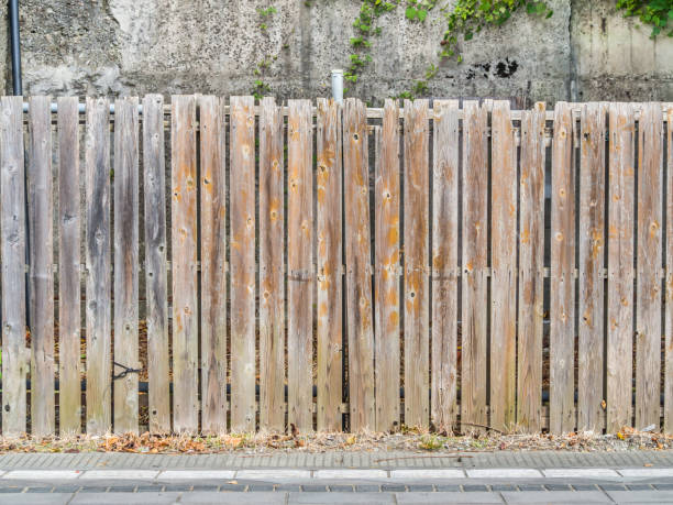 istock Abstract old stripes wooden fence pattern. 827276396