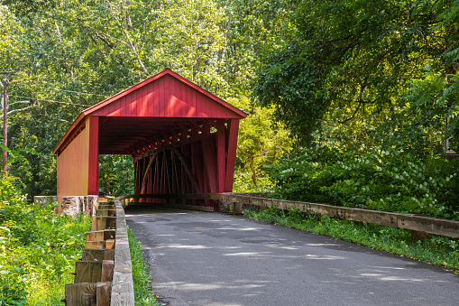 The Parvin Covered Bridge is a historic wooden bridge that spans Lost Creek. Constructed in 1921, it is one of the few remaining covered bridges in the state and was added to the National Register of Historic Places on November 29, 1979. This recognition underscores the bridge's significance as a historic landmark and ensures its preservation for future generations to enjoy and appreciate.  The bridge was named after a local family, the Parvins, who were early settlers in the area. It was built using the Howe truss design, which was a popular method for covered bridges at the time. The bridge is notable for its classic covered bridge design with a gabled roof and wooden siding.  The Parvin Covered Bridge Is located in Lane County, Oregon, USA.